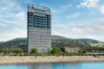tall wood building overlooking hills and lake
