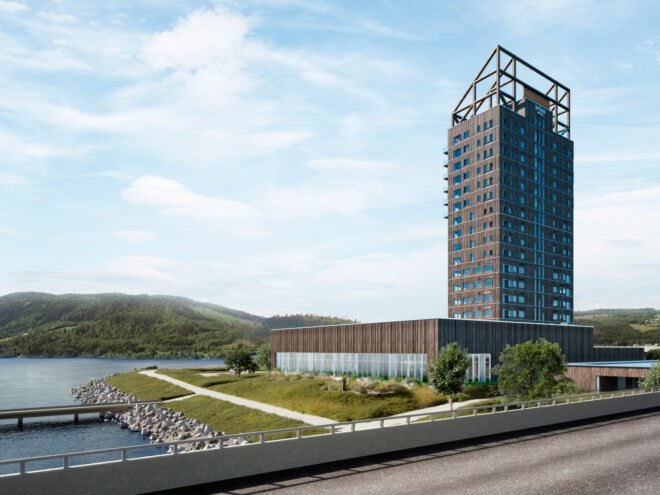 tall wood building overlooking hills and lake