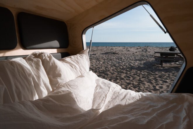 bed beside open door of trailer