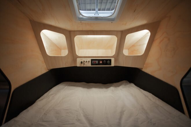 interior of geometric trailer with wood walls and built-in cubbies