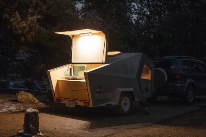 rear kitchenette of a trailer lit with LED lights at night