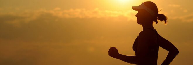 woman's silhouette running at sunset