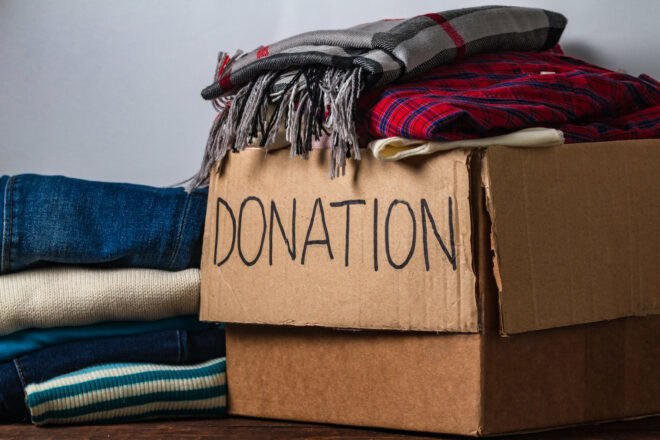 donation cardboard box with clothing and blankets