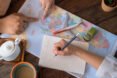 people plan out vacation with map and notes
