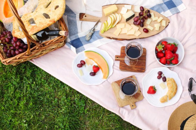 flat-lay of picnic foods on picnic blanket