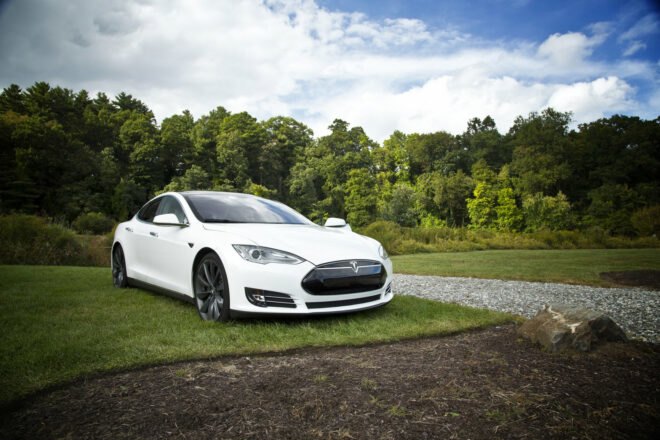 White Tesla parked on a lawn
