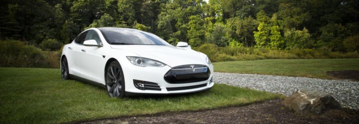 White Tesla parked on a lawn