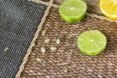 lemon and limes and their seeds on burlap