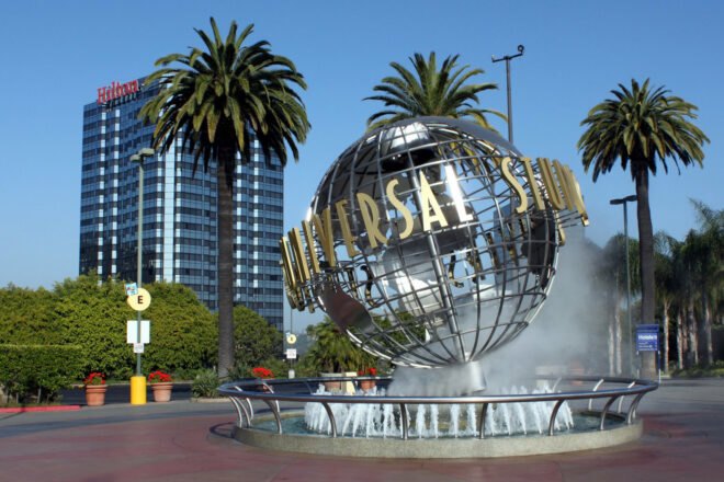 globe sculpture with UNIVERSAL sign in front