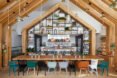 communal kitchen with wood gable shapes and multi-colored bar seats