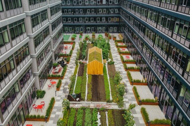 aerial view of gardens and wood shed in center of multiple apartment buildings