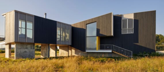 modern home sitting above expansive marshland