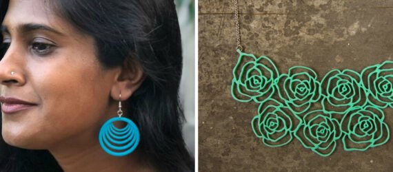 On the left, profile of a woman with colorful pendant earrings. On the right, green floral necklace.