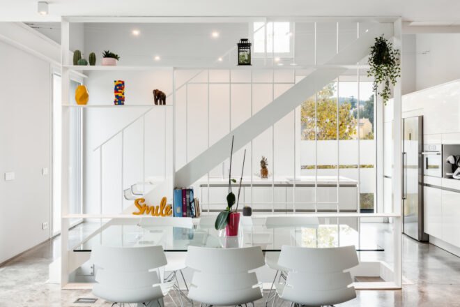 all white living area with glass dining table and white chairs