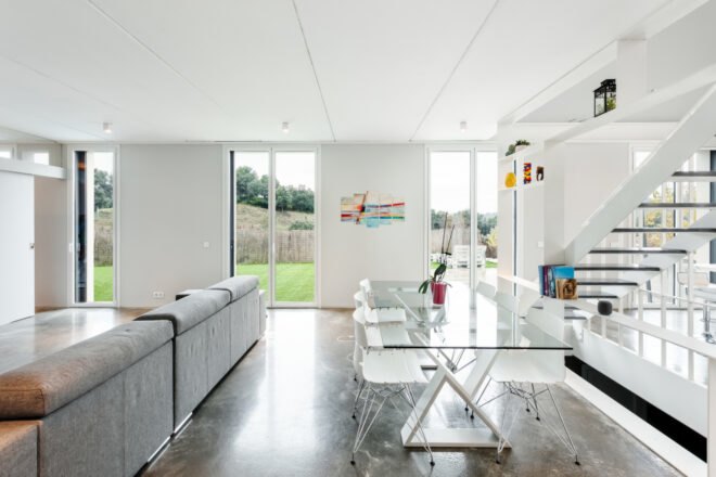 all white living space with glass dining table