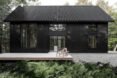black cabin with wooden deck