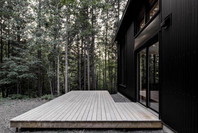 wooden deck connected to black cabin