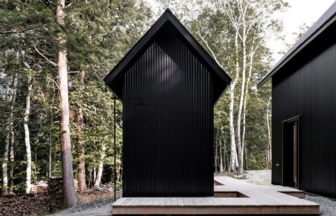 wooden walkways connecting two black cabins