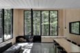 interior living space with four slender windows and a wood-burning chimney
