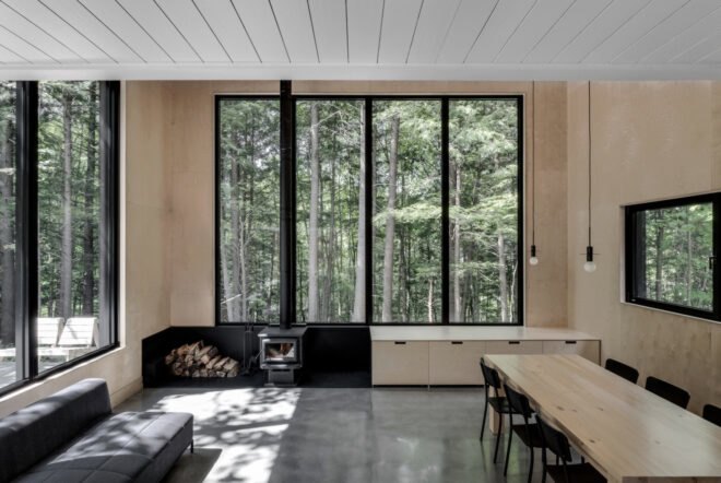interior living space with four slender windows and a wood-burning chimney