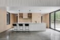 contemporary kitchen with bar stools in front of white kitchen island