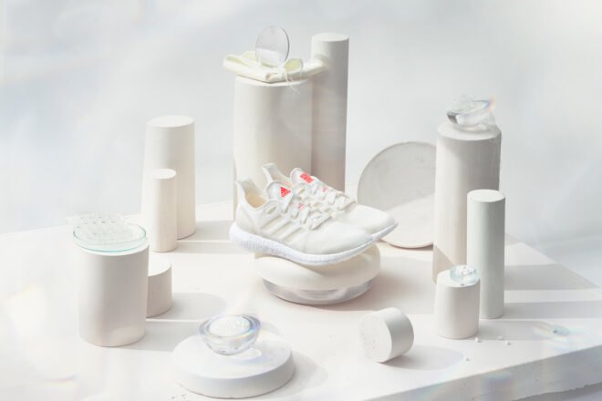 white recycled running shoes on display with white background