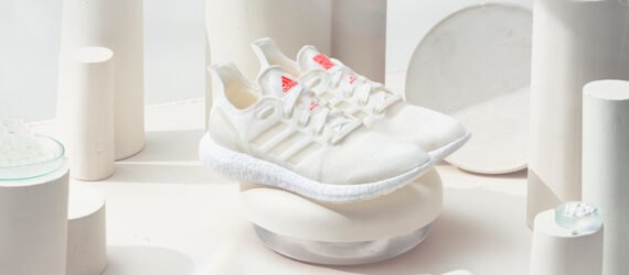 white recycled running shoes on display with white background