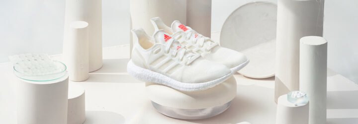white recycled running shoes on display with white background
