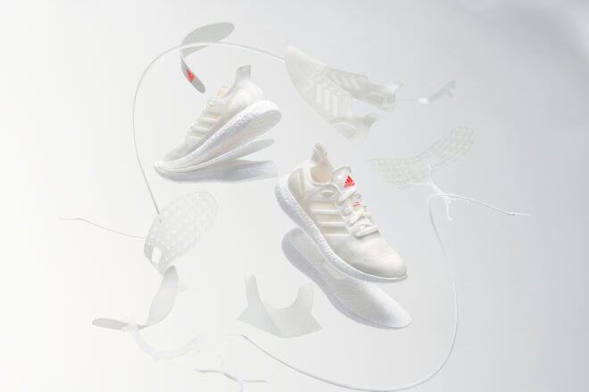white recycled running shoes on display with white background