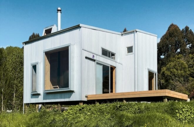 tiny cabin clad in corrugated metal with large window