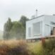 tiny cabin clad in corrugated metal with large window
