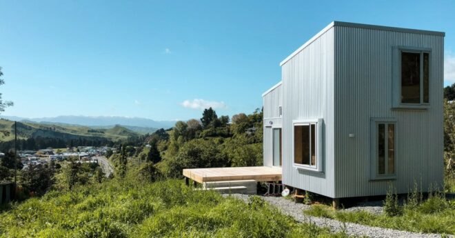 tiny cabin clad in corrugated metal with large window