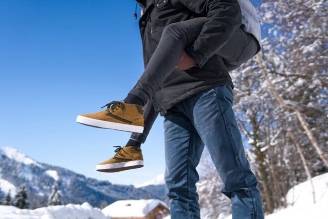 person wearing brown shoes in the snow