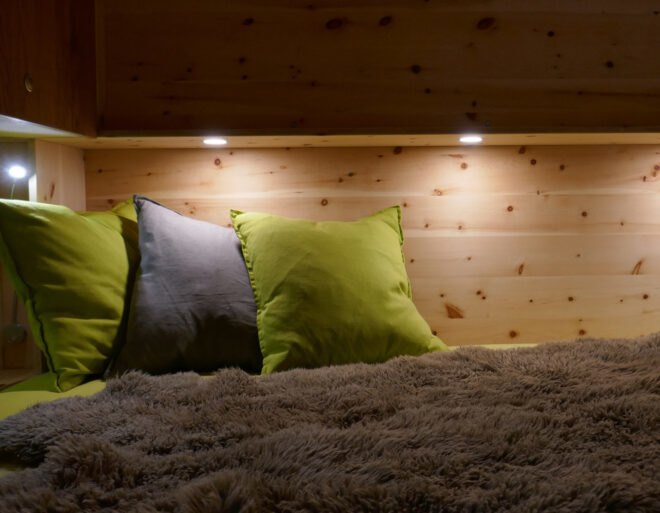 bedding area with wood walls and recessed lighting