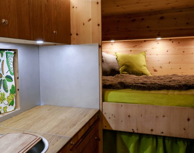 sleeping area with green and gray pillows