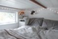 bed in sleeping loft in tiny home