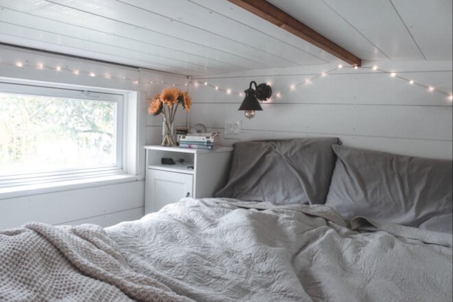 bed in sleeping loft in tiny home