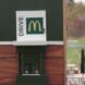 minature McDonald's restaurant with bees at drive-thru window