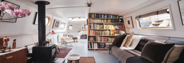large living space with bookcases and kitchen