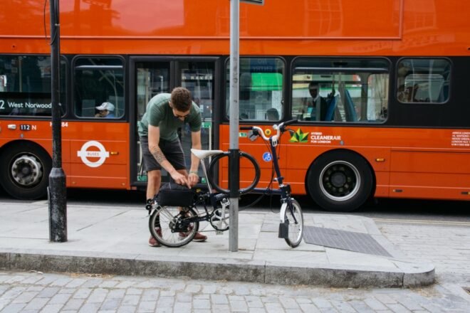 man locking his bike to street pole