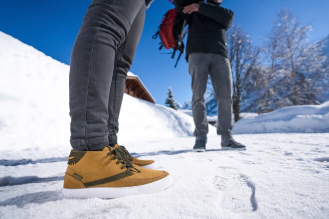 person wearing brown shoes in the snow