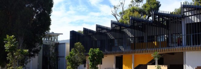 black and yellow building with sawtooth roof