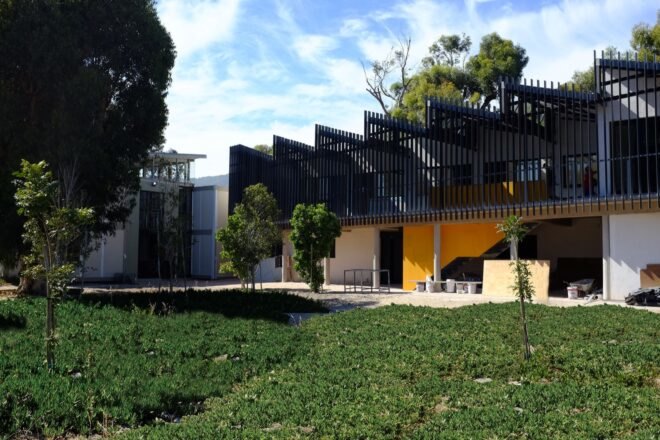 black and yellow building with sawtooth roof