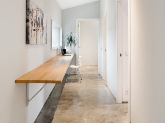 hallwway with white walls and wooden shelf