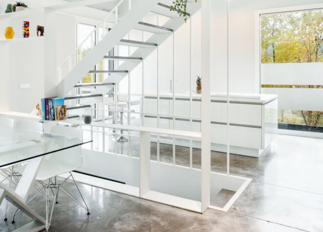 all white living area with steel staircase