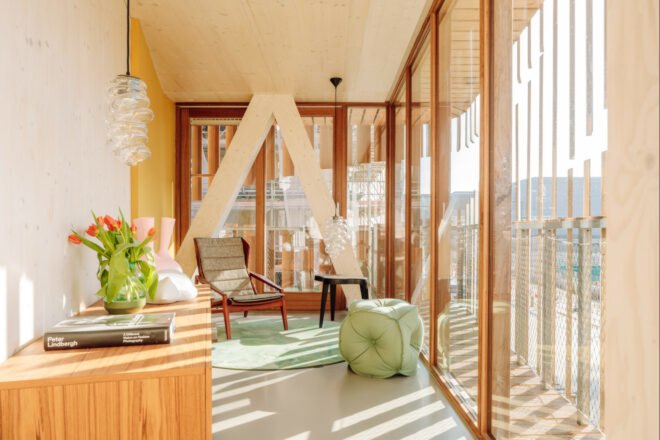 living space with small chair and glass walls