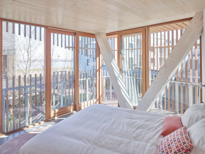 white bed facing glass walls