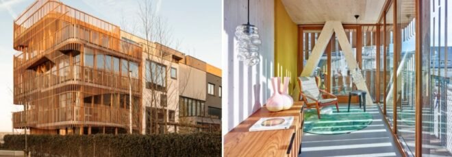 On the left, building wrapped in wooden screen. On the right, living area with wood cabinets and a small seating space.
