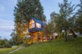 gabled treehouse with large glass facade