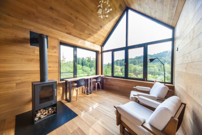 wood-lined room with wood-burning fireplace
